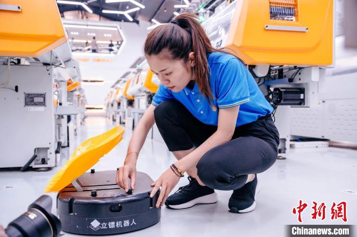 圖為員工在調(diào)試AGV搬運(yùn)機(jī)器人?！±钅宪?攝